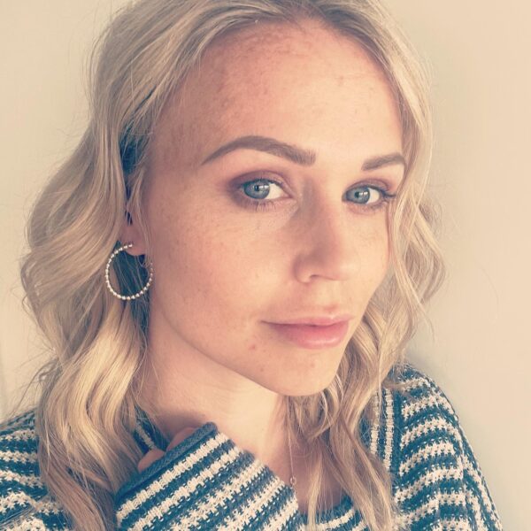 A blonde woman wearing handmade silver hoops