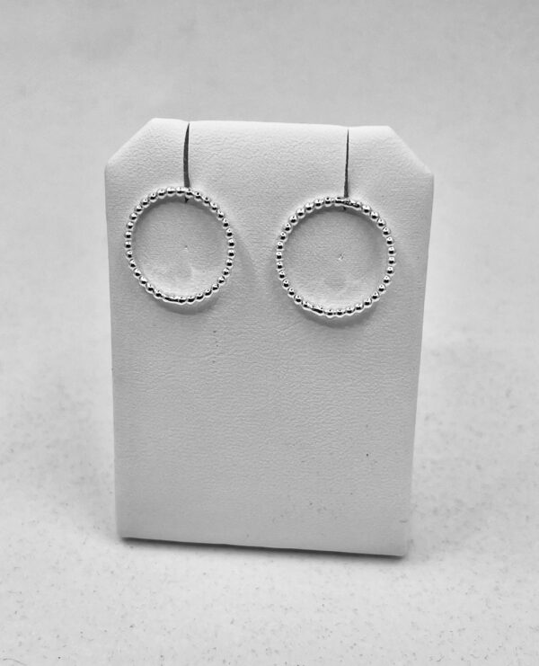 Earrings shaped as circles of thin, dotted silver wire.